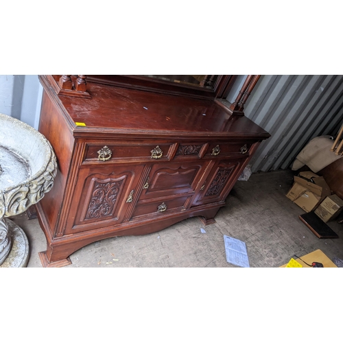 309 - A late Victorian mahogany mirrored back cabinet having a stepped cornice two finials, egg and dart m... 