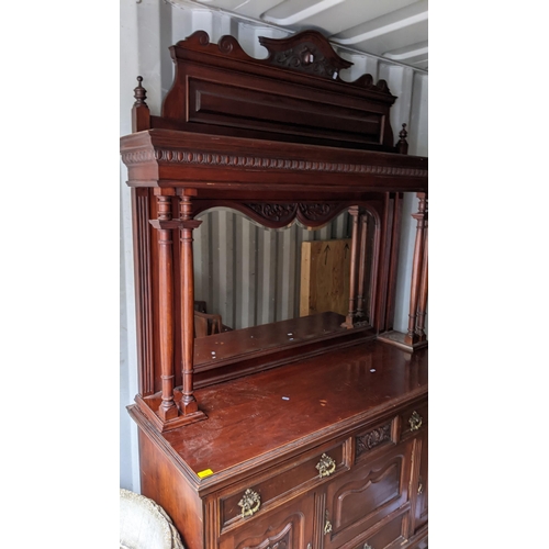 309 - A late Victorian mahogany mirrored back cabinet having a stepped cornice two finials, egg and dart m... 