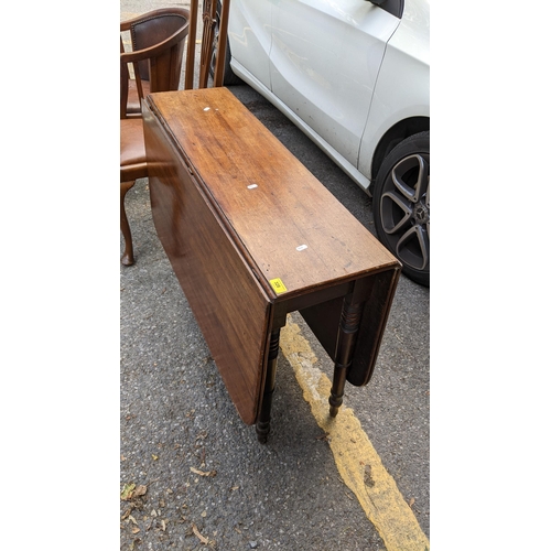 328 - An early 19th century mahogany gateleg table together with three pierced splat back chairs and a tub... 