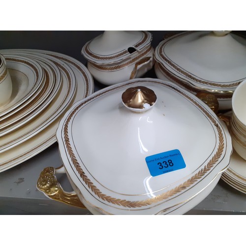 383 - A cream glazed Wedgwood dinner service having a gilt Roman laurel leaf frieze to include 12 dinner p... 