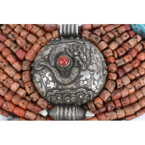 112 - A Tibetan or Nepalese coral, turquoise and white metal bib necklace, late 19th/early 20th century, w... 