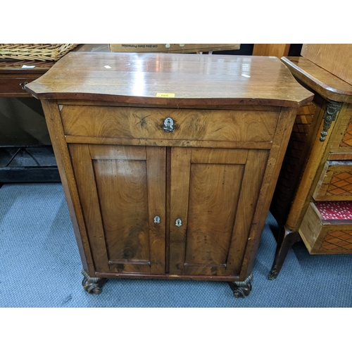 105 - A late 19th early 20th century French walnut cabinet having mother of pearl escutcheons and a front ... 