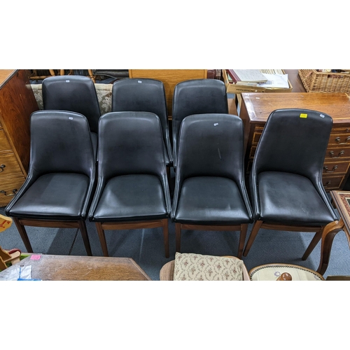 114 - A set of eight retro black vinyl and teak dinning chairs possibly by Burgess together with a teak ex... 