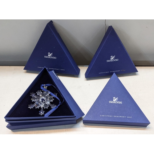 338 - Four boxed Swarovski Christmas ornaments,  2004, 2005, 2007 and 1996 in a 2006 box Location:R2:3