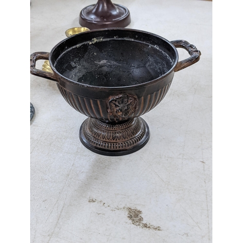 352 - A mixed lot of metalware to include a brass oil lamp, a bronze twin handled footed bowl having lion ... 