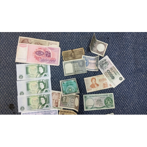 399 - A group of foreign and British banknotes to include a Straits Settlement One Dollar note, three 10-s... 