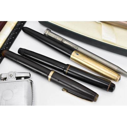 91 - A collection of pens and lighters, to include a Cross matt bronze fountain pen in box, with chrome g... 