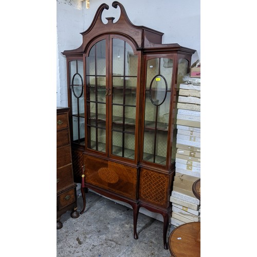 407 - Late Victorian inlaid breakfront mahogany display cabinet, broken swan neck pediment above twin arch... 