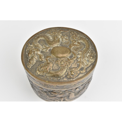 117 - A Chinese export silver oval lidded box, circa 1900, embossed with dragons in clouds, the underside ... 