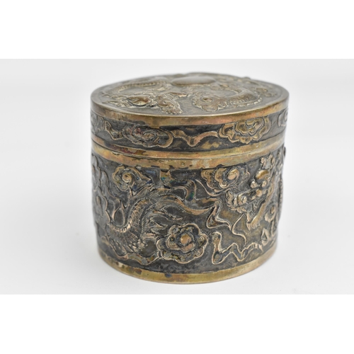 117 - A Chinese export silver oval lidded box, circa 1900, embossed with dragons in clouds, the underside ... 