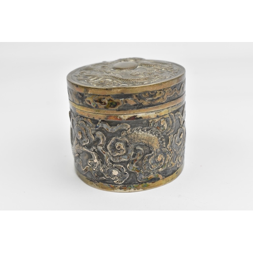 117 - A Chinese export silver oval lidded box, circa 1900, embossed with dragons in clouds, the underside ... 