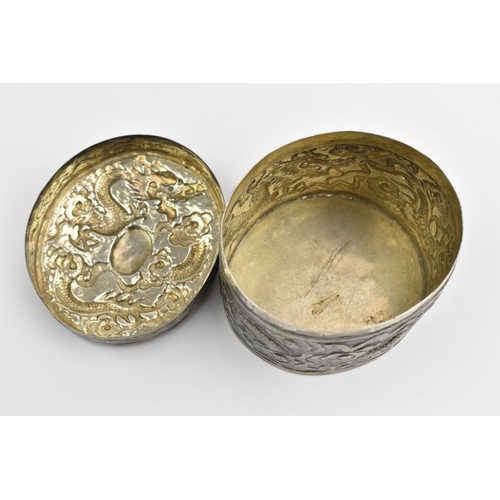 117 - A Chinese export silver oval lidded box, circa 1900, embossed with dragons in clouds, the underside ... 