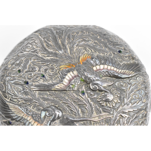 118 - A Japanese white metal and enamel circular box, the lid with raised decoration of birds in paradise ... 