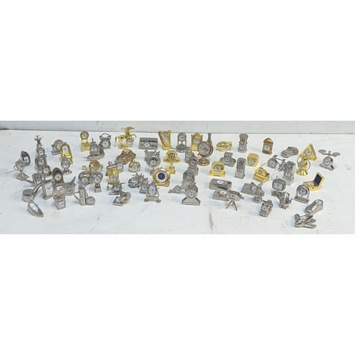 121 - A collection of approx 70 miniature novelty quartz clocks in various forms to include Ship, Car, Pip... 