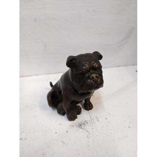 106 - An early 20th century small bronze model of a seated bulldog, along with a carved onyx sculpture of ... 