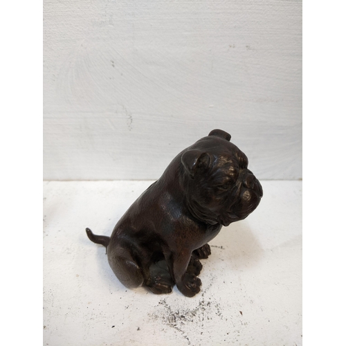 106 - An early 20th century small bronze model of a seated bulldog, along with a carved onyx sculpture of ... 