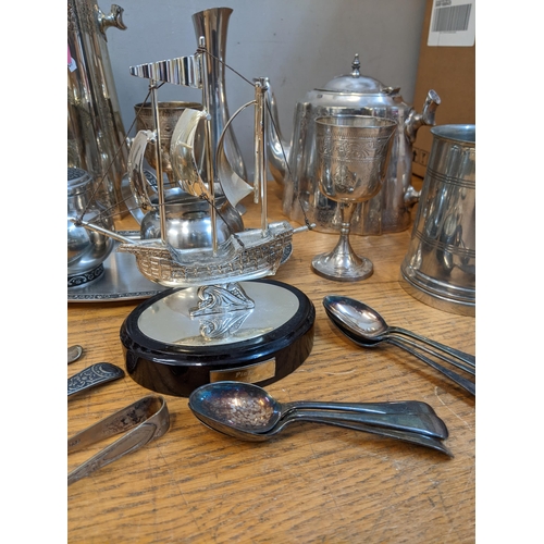 110 - A mixed lot of silver, silver plate, pewter and other items to include a coffee and teapot, model of... 