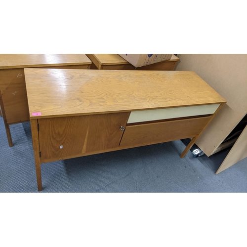 12 - A Richard Young for G-Plan sideboard having a cupboard door and two drawers, 71h x 132.5w, together ... 