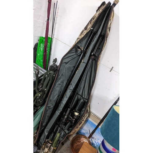 14 - Carp related fishing equipment to include three rods with reels, umbrellas, Bovey, keep nets, tackle... 