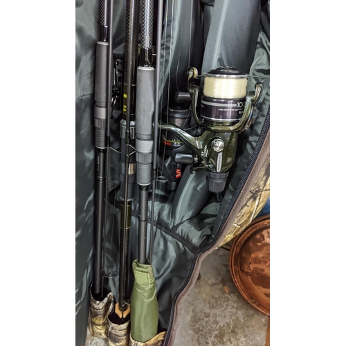 14 - Carp related fishing equipment to include three rods with reels, umbrellas, Bovey, keep nets, tackle... 