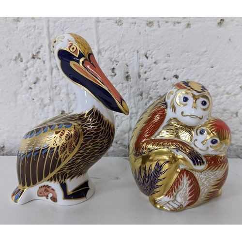 18 - A Royal Crown Derby Pelican paperweight with gold stopper, together with two monkey paperweights wit... 