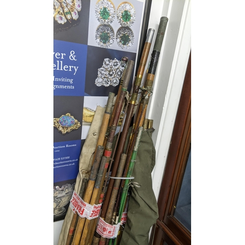 32 - A collection of vintage fishing rods, Location: G