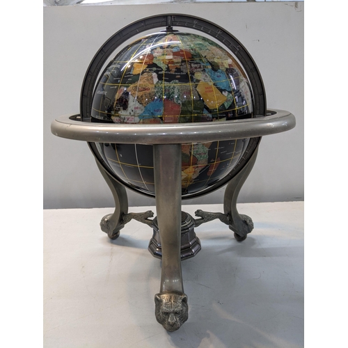 333 - A globe set with semi and non-precious stones set in a metal supporting frame on lion and ball feet
... 