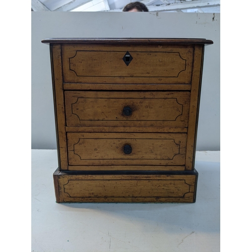 334 - A two drawer birch collectors chest with a hinged lid and inlaid decoration, raised on plinth
Locati... 