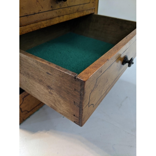 334 - A two drawer birch collectors chest with a hinged lid and inlaid decoration, raised on plinth
Locati... 