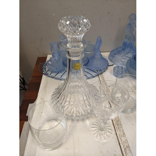 335 - Glassware to include blue glass dressing table items, a figural centre piece, glasses, decanter and ... 