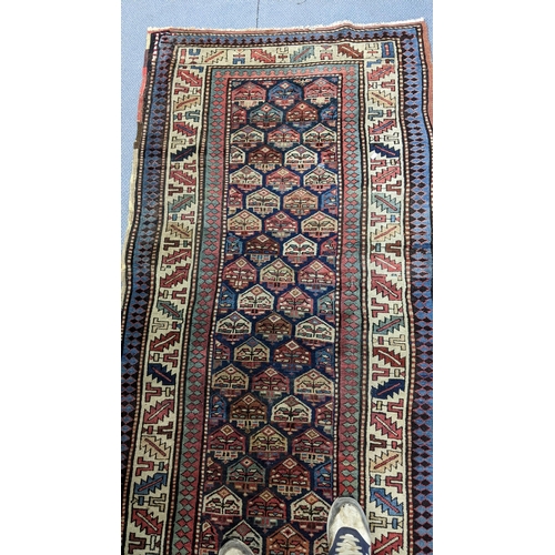 42 - A hand woven Turkish rug having repeating motifs and multiguard borders, 235 x 106, Location: A2M