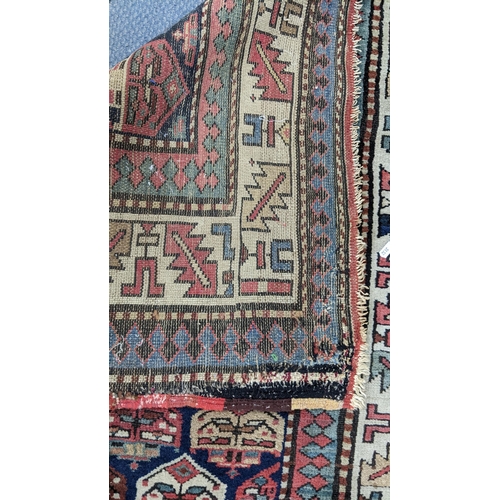 42 - A hand woven Turkish rug having repeating motifs and multiguard borders, 235 x 106, Location: A2M