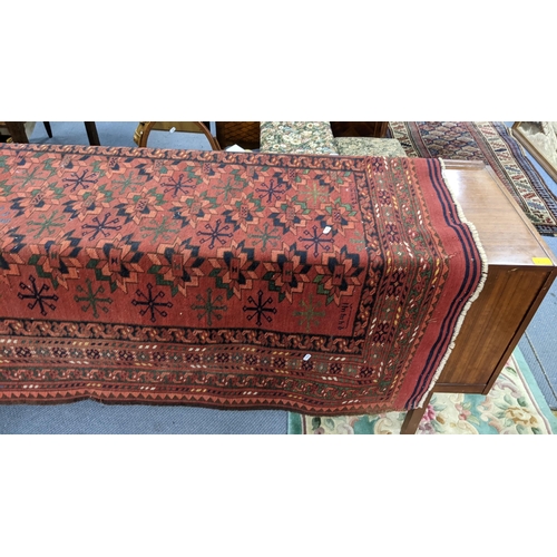 43 - A hand woven Turkish rug having a red round, multiguard borders and tasselled ends, 184 x 128, Locat... 