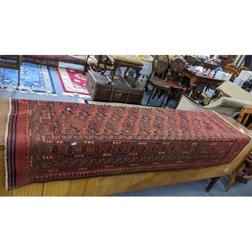 43 - A hand woven Turkish rug having a red round, multiguard borders and tasselled ends, 184 x 128, Locat... 