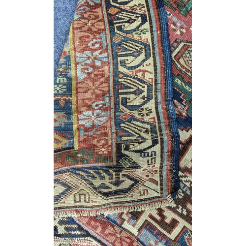 44 - A Turkish hand woven rug having a blue ground with four motifs and beige border, 146 x 104.5, Locati... 