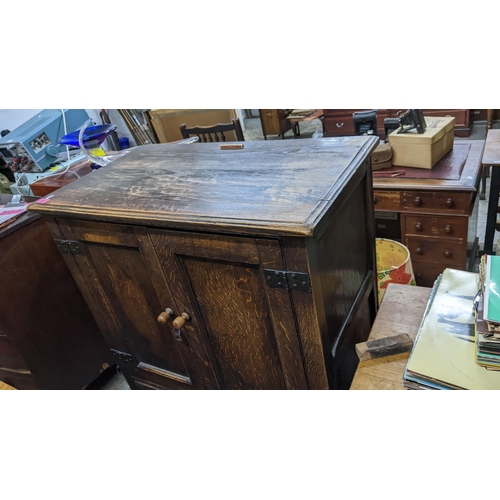 52 - An early 20th century oak cabinet with twin panelled doors, over three drawers, 125H x 81w, Location... 