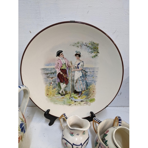 71 - A selection of French Quimper and other ceramics to include a pair of cabinet plates signed B Fremon... 