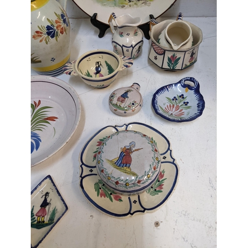 71 - A selection of French Quimper and other ceramics to include a pair of cabinet plates signed B Fremon... 