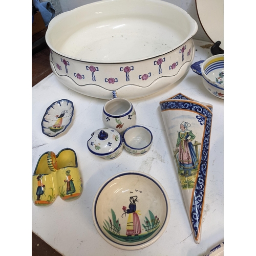 71 - A selection of French Quimper and other ceramics to include a pair of cabinet plates signed B Fremon... 