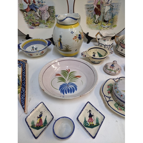 71 - A selection of French Quimper and other ceramics to include a pair of cabinet plates signed B Fremon... 