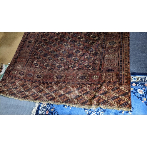 8 - An Afghan hand woven rug having elephant foot motifs, geometric designs and tasselled ends, 328 x 21... 