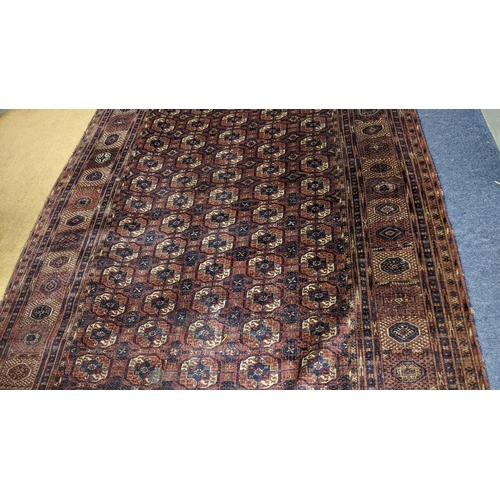 8 - An Afghan hand woven rug having elephant foot motifs, geometric designs and tasselled ends, 328 x 21... 