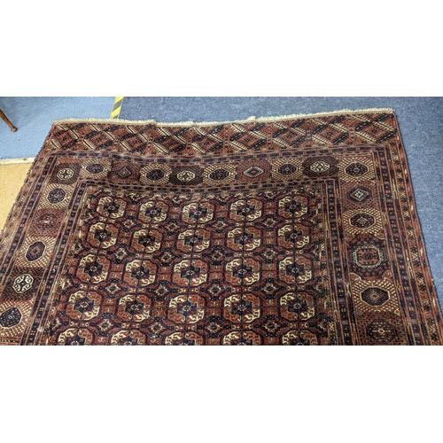 8 - An Afghan hand woven rug having elephant foot motifs, geometric designs and tasselled ends, 328 x 21... 