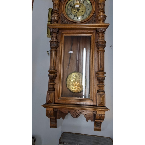 1 - A 19th century walnut carved Vienna 8-day wall clock, having a stepped cornice and reeded columns
Lo... 