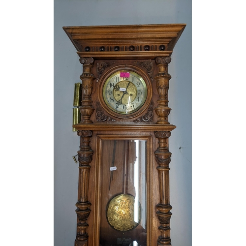 1 - A 19th century walnut carved Vienna 8-day wall clock, having a stepped cornice and reeded columns
Lo... 