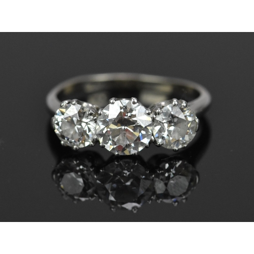 A platinum and three stone diamond ring, set with brilliant cut diamonds, the central largest one approx 1.4 carat, flanked by two similar sized diamonds approx 0.5 carat each, all diamonds similar colour grade J-G, clarity of central stone: VVS2, size R 1/2