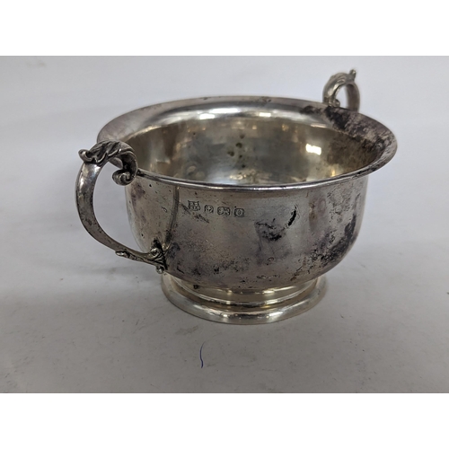 111 - An early/mid 20th century twin handled silver footed bowl, engraved to side with monogram, hallmarke... 