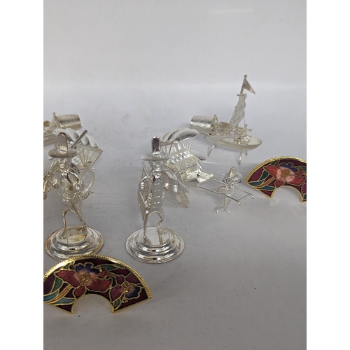 118 - A collection of six stamped 925 sterling silver menu holders in the form of Oriental figures and boa... 