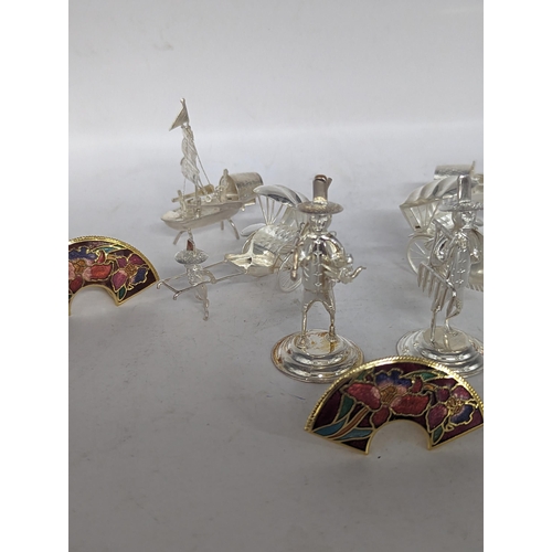 118 - A collection of six stamped 925 sterling silver menu holders in the form of Oriental figures and boa... 