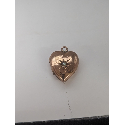 121 - A 9ct gold heart shaped locket pendant inset with central seed pearl, 2.5g
Location: CAB3